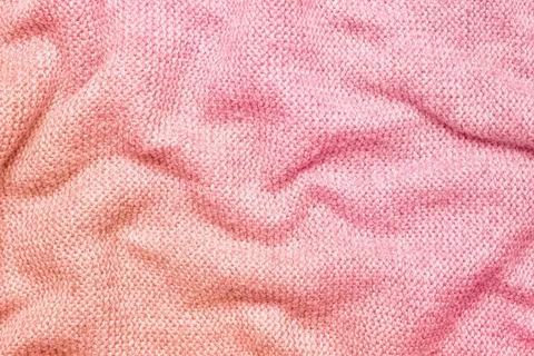 A soft and textured gradient pink knitted fabric with gentle waves and folds Stock Photos