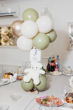 Soft balloons float above a festive table setting Stock Photos