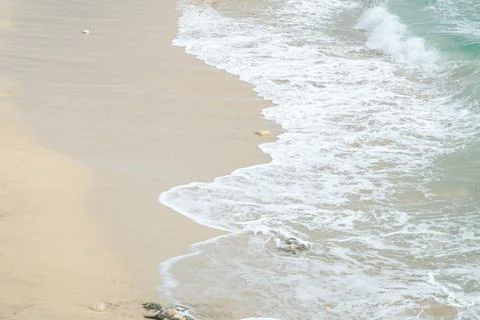 Soft Beach Waves Rolling onto Sandy Shore, Sparkling Under the Sun, Creatin.. Stock Photos