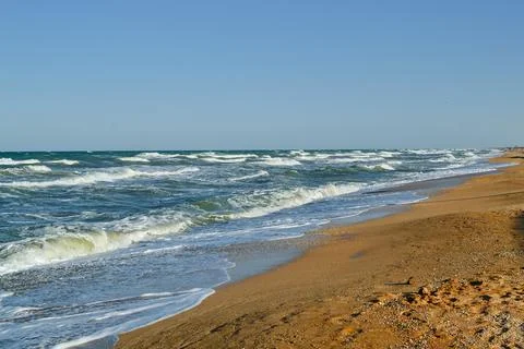 Soft Beach Waves Rolling to the Shore, Glimmering in the Sunlight, Inviting Stock Photos