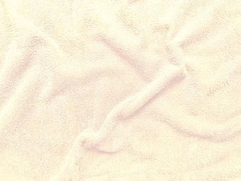 Soft beige fabric texture with elegant folds in pastel tones abstract closeup Stock Photos