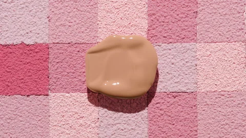 Soft beige foundation smear on pink mosaic background Stock Footage 341664536