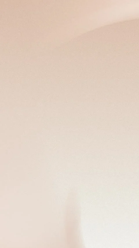 Soft beige gradient with subtle light arc, seamless loop background, 4K. Stock Footage 309956600