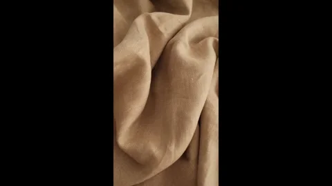 Soft beige linen fabric. Expensive fabric for luxury clothes. Stock Footage 317094256