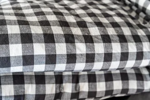 Soft black and white checkered fabric in a stacked arrangement, perfect for home Stock Photos