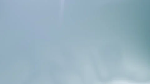 Soft blue abstract shapes create a serene gradient seamless loop background. 4K. Stock Footage 309956849