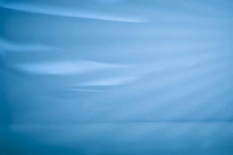 Soft blue abstract waves and flowing shadows with empty tabletop for elegan.. Fotos de archivo