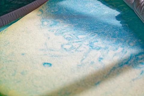 Soft blue and beige patterned fabric with sunlight and shadow effects Stock Photos