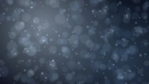 Soft blue and gray bokeh lights drift slowly downward across a blurred Stock Footage 345185695