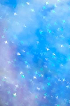 Soft blue background with four pointed star bokeh. Stock-Fotos