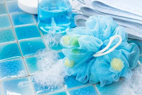 Soft blue bath puff or sponge  on blue tile  background Stock Photos