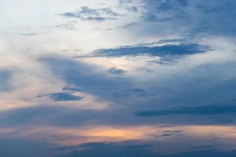 Soft blue evening sky layered with wispy and billowing clouds Stock Photos