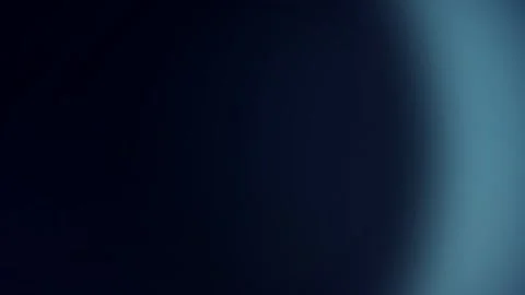 Soft blue lens flare light leak moving on dark background Stock Footage 340877578