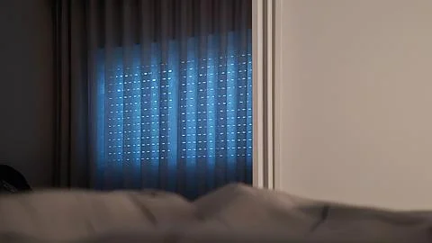 Soft blue light from a window is reflected in a bedroom mirror Stock Photos