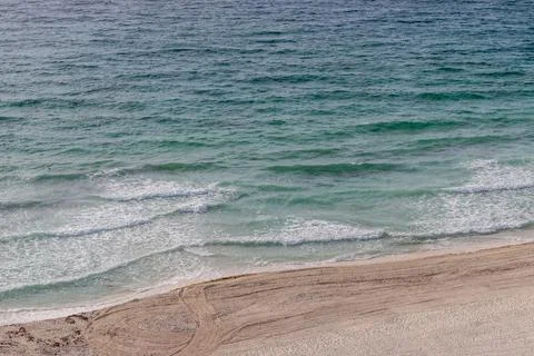 Soft blue ocean wave on clean sandy beach Stock-Fotos