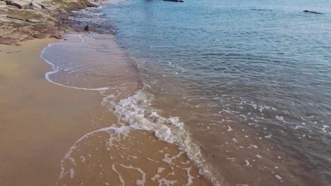 Soft blue ocean wave on sandy beach  Stock Footage 128530152