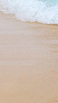 Soft Blue Ocean Wave On Sandy Beach. Background with copy space. Selective focus Stock Photos