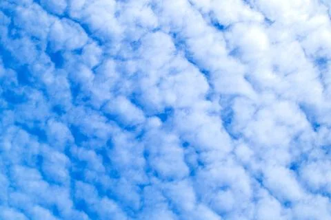 Soft blue sky with altocumulus cloud pattern and fluffy white texture Stock Photos