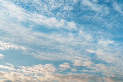 Soft Blue Sky Covered with Delicate White Clouds Фото
