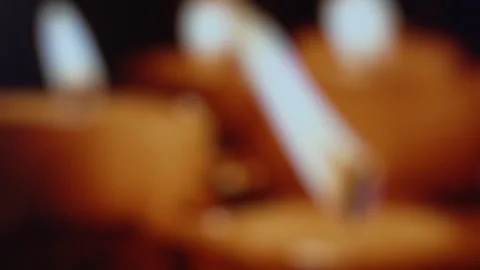 Soft blurred view of burning candles with warm flickering flames creating an Stock Footage 324719107