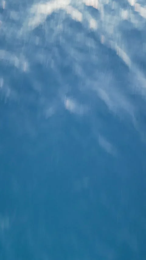 Soft, blurry image of water in shades of blue and pink at sunset, aerial view of Stock Footage 340532955