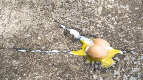 Soft boiled egg broken on the floor., copy space for text., food expired conc Stock Photos