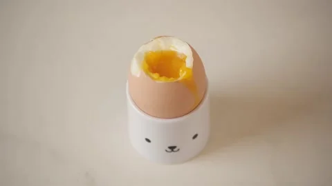 Soft boiled egg in egg cup Video stock 130950827