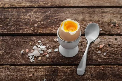 Soft boiled egg on wwoden background, rustic style, copy space Stock Photos