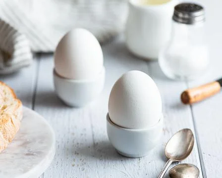 Soft-boiled eggs, breakfast on a white background Stock Photos