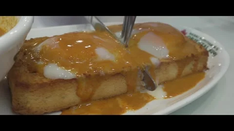 Soft boiled eggs on toasted bread with curry sauce, close up Stock Footage 292975390