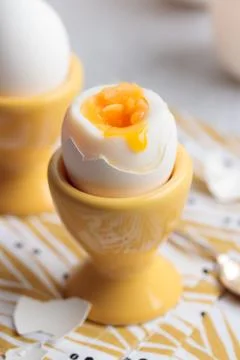 Soft-boiled eggs in a yellow eggcups Stock Photos