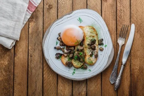 Soft-boiled goose egg with wild mushrooms and bread, copy space Stock Photos