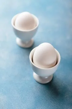 Soft-boilled eggs in an egg-cup Stock Photos