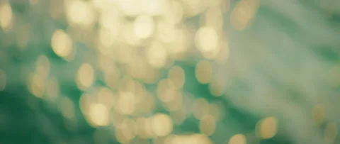Soft bokeh circles play over turquoise sea water at summer sunset Stock Footage 310416650