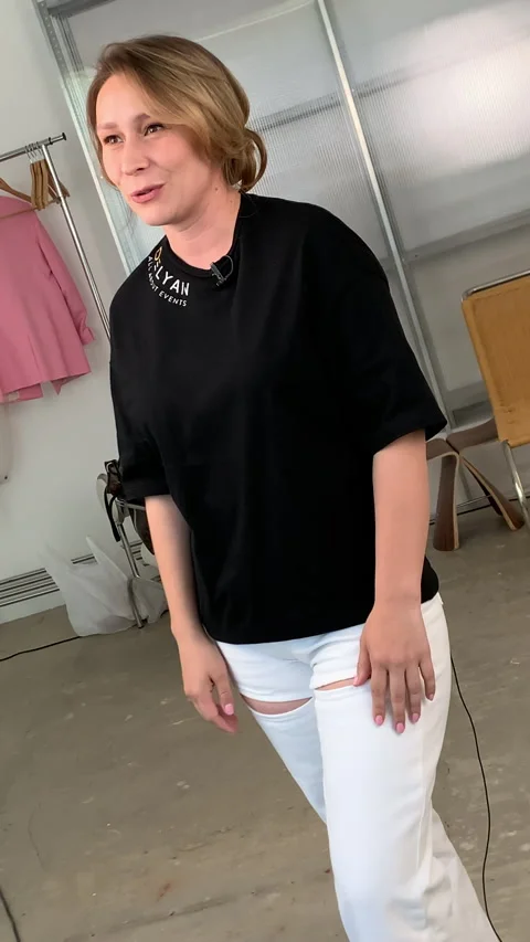 Soft-box shines on host actively gesticulating in front of camera Stock Footage 303065592