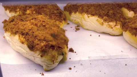 Soft bread topped with savory meat floss displayed at bakery Stock Footage 340484116
