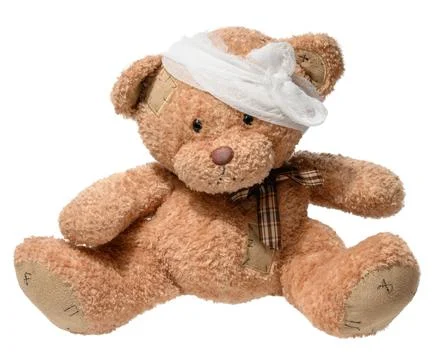 Soft brown teddy bear with stitched patches, head bandage, and plaid bow ti.. Foto stock