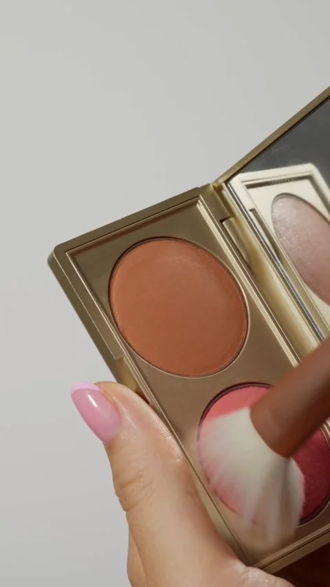 Soft brush picks up pink powder from makeup palette Video stock 331769838