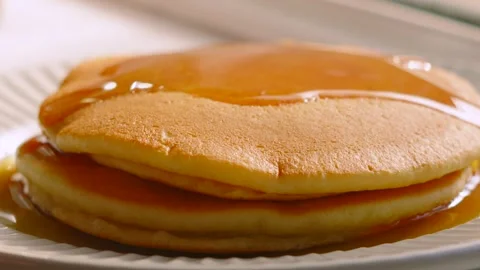 Soft Buttermilk Pancakes Covered in Maple Syrup with Golden Gooey Shine. Stock Footage 338425070