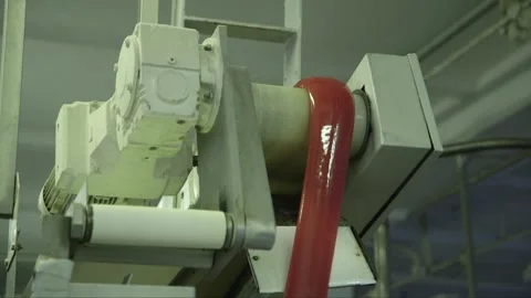 Soft caramel falls over the edge of a conveyor belt in a candy factory Stock Footage 242863010