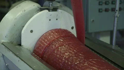 Soft caramel is spun on a rotating cone-shaped mold in a candy factory Stock Footage 242863092