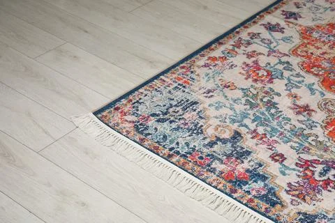 Soft carpet with pattern on white laminated floor indoors Stock Photos