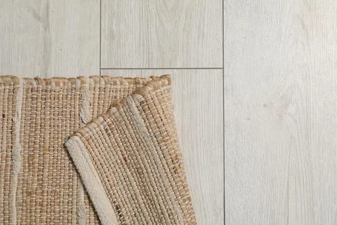 Soft carpet with pattern on white laminated floor indoors, top view. Space .. Stock Photos