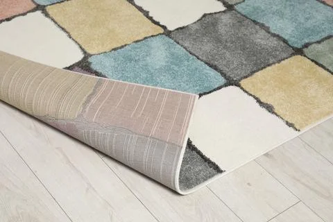 Soft carpet with pattern on white laminated floor indoors Stock Photos