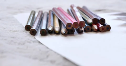On soft carpet there is a pack of pencils of different colors. Видео 276626724