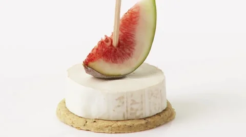 Soft cheese and fig on cocktail stick on cracker Stock Footage