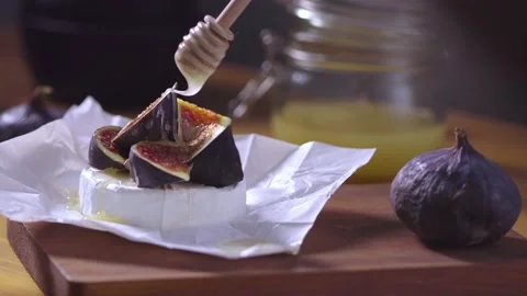 Soft cheese appetizer topped with sliced figs, honey on wooden background Stock Footage 218232361