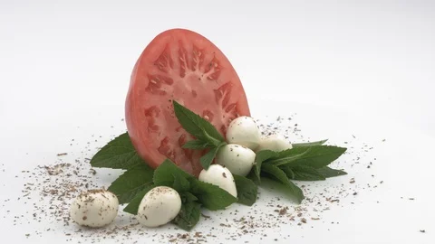 Soft cheese, tomato, mint and fragrant spices. White background. Stock Footage 129850603