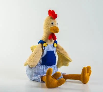 Soft children's toy. Multi-colored rooster on a white background. Foto stock