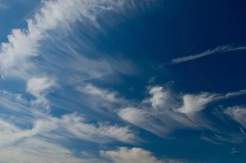 Soft cirrus clouds driven by wind in a blue sky Stock-Fotos
